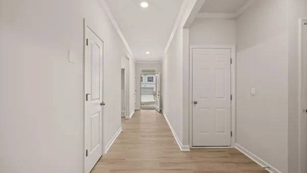 a view of a hallway with wooden floor