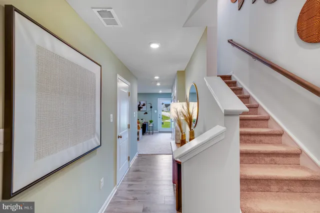 a view of entryway and hall with wooden floor