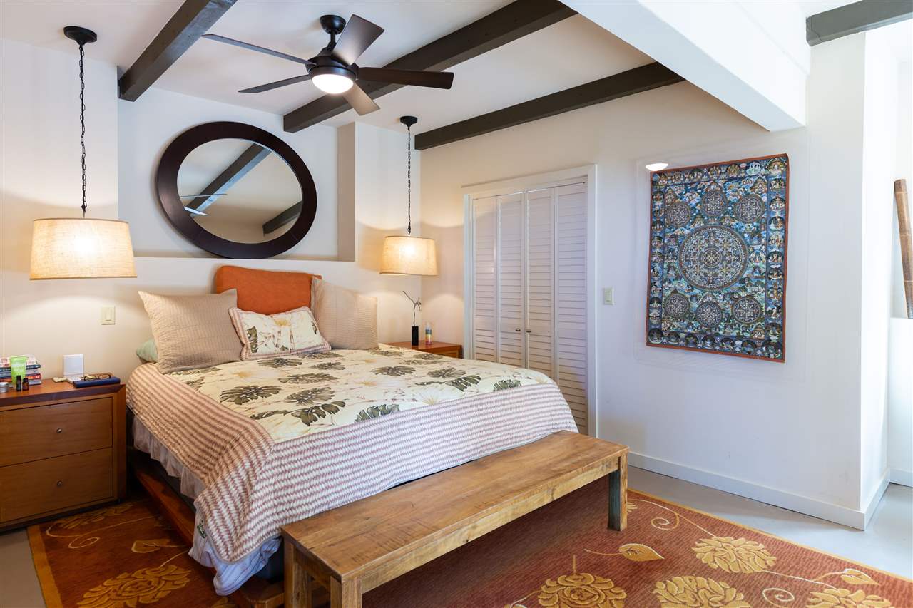 320 Lower Kimo Drive Kula, HI 96790 - Photo 23 of 27 a bedroom with a bed and a lamp