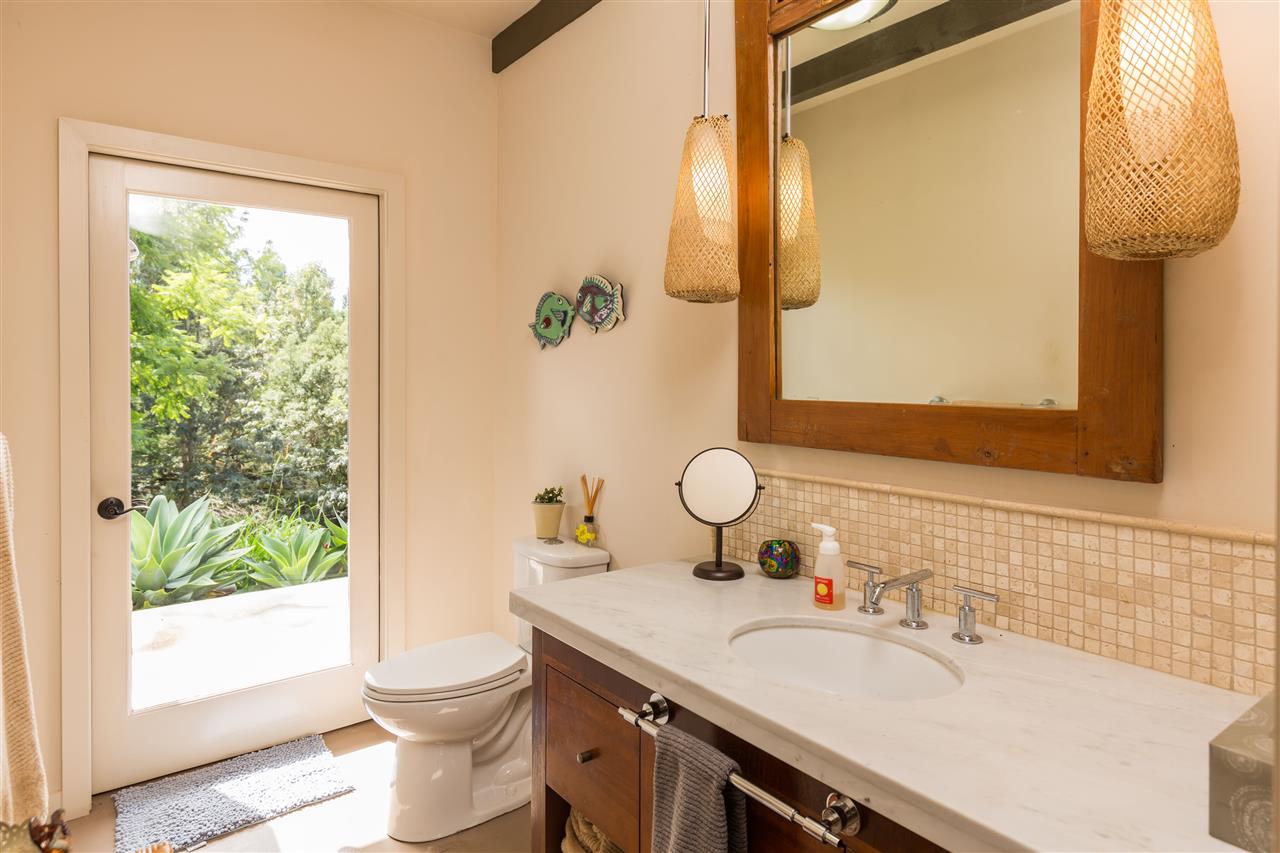 320 Lower Kimo Drive Kula, HI 96790 - Photo 24 of 27 a bathroom with a granite countertop sink toilet and mirror