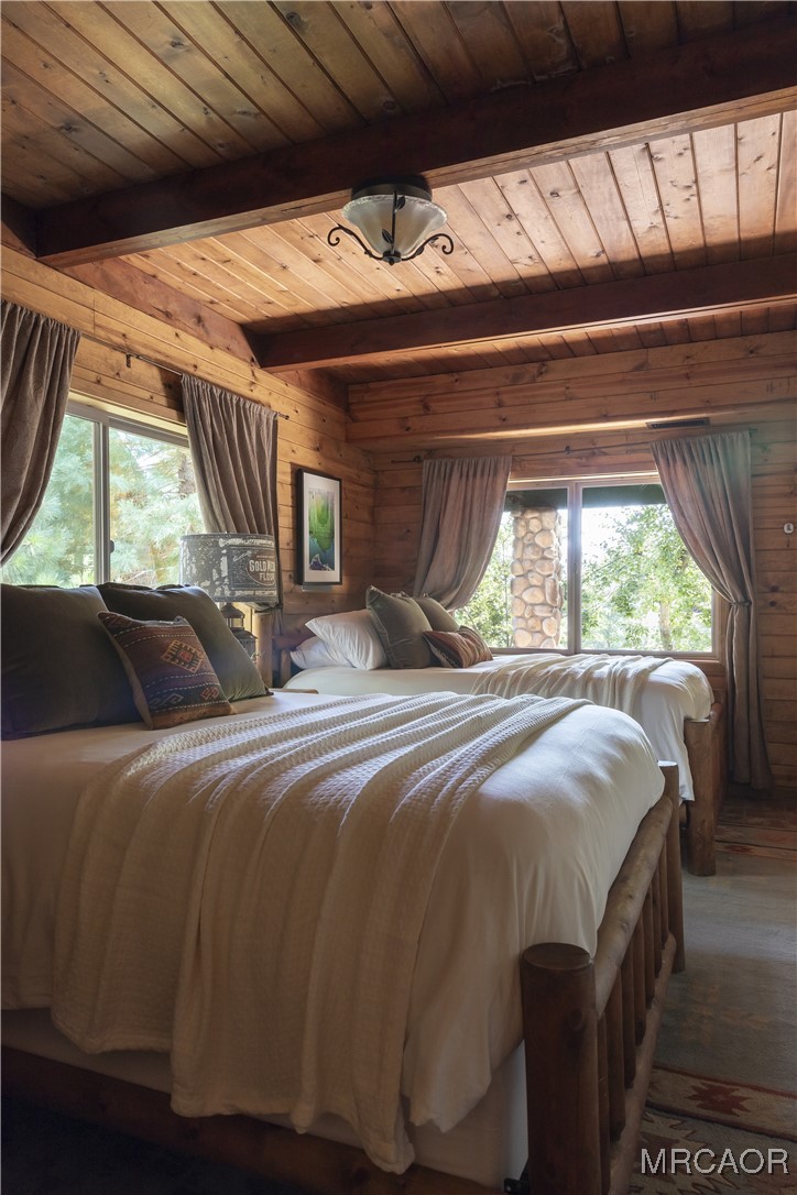 27710 West Shore Road Lake Arrowhead, CA 92352 - Photo 18 of 47 a bed sitting in a bedroom next to a window