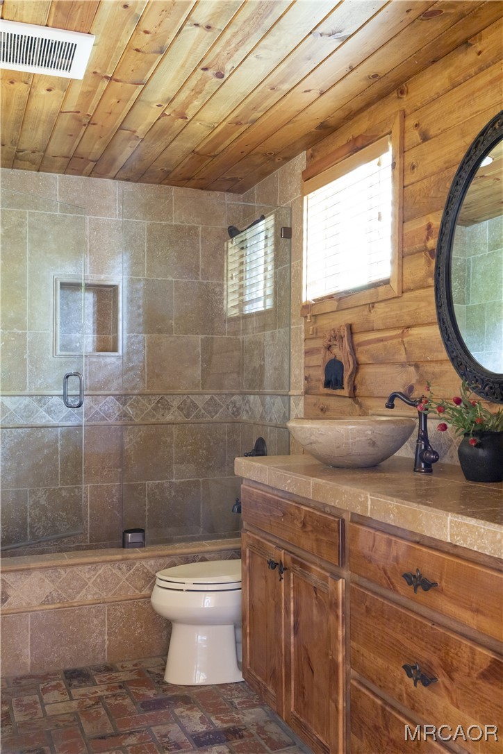27710 West Shore Road Lake Arrowhead, CA 92352 - Photo 20 of 47 a bathroom with a toilet a sink and mirror