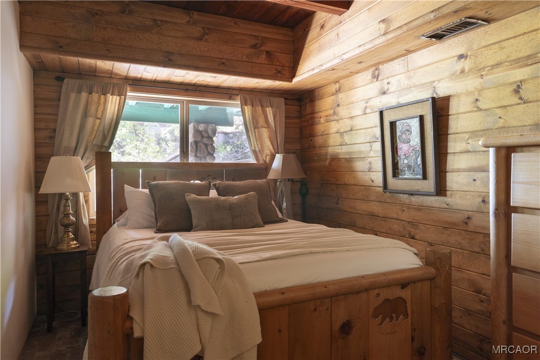 27710 West Shore Road Lake Arrowhead, CA 92352 - Photo 21 of 47 a bedroom with a bed and a window