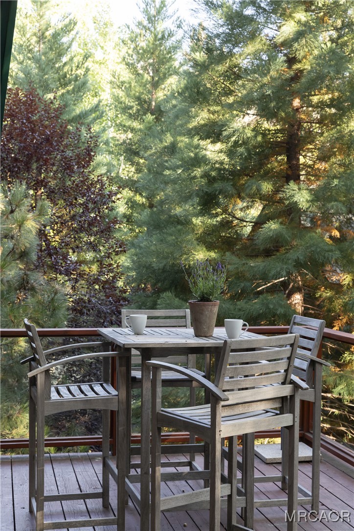 27710 West Shore Road Lake Arrowhead, CA 92352 - Photo 22 of 47 a view of a chairs and table on the deck