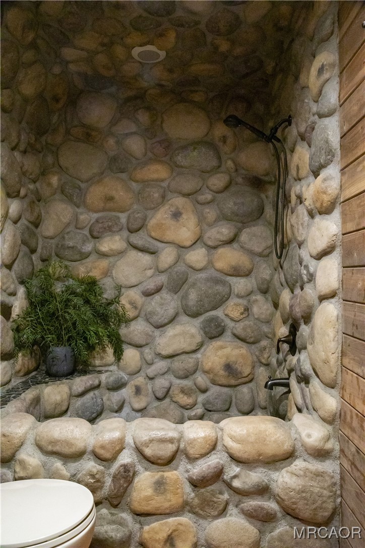 27710 West Shore Road Lake Arrowhead, CA 92352 - Photo 34 of 47 a view of a couch with white walls