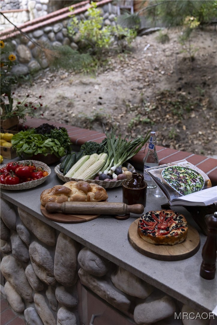 27710 West Shore Road Lake Arrowhead, CA 92352 - Photo 41 of 47 a view of a wooden table and chairs in a patio