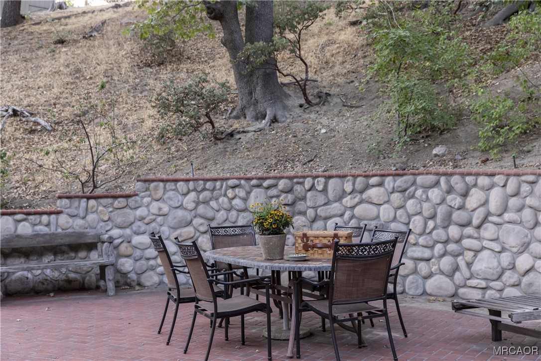 27710 West Shore Road Lake Arrowhead, CA 92352 - Photo 43 of 47 a view of a dining table and chairs in the patio
