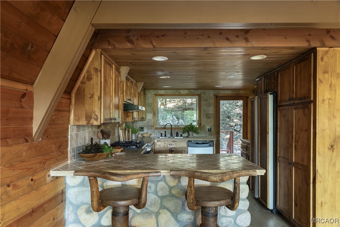 27710 West Shore Road Lake Arrowhead, CA 92352 - Photo 6 of 47 a kitchen with a sink and chairs