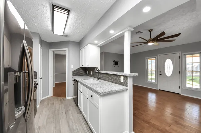 a kitchen with sink cabinets and refrigerator