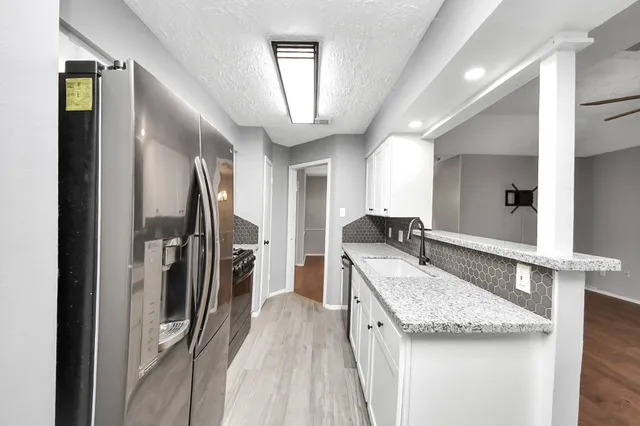 a kitchen with a refrigerator and a sink