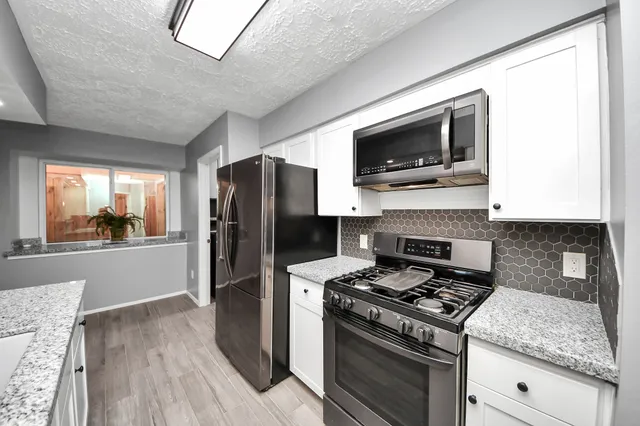 a kitchen with a stove and a microwave