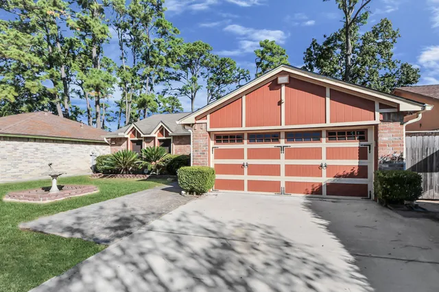 a view of a house with a yard and garage