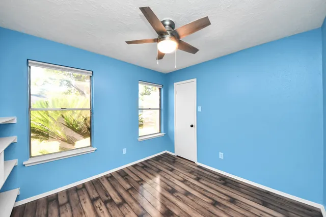 a view of a livingroom with a window and a ceiling fan