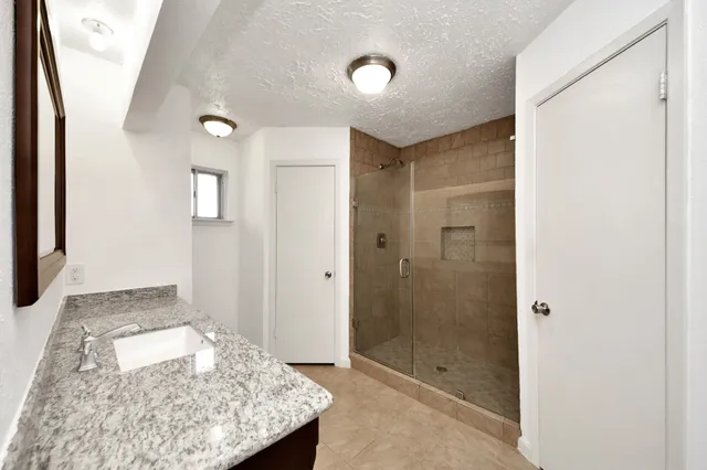a bathroom with a shower and a sink