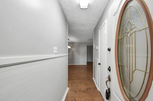 a view of a hallway with wooden floor and entryway