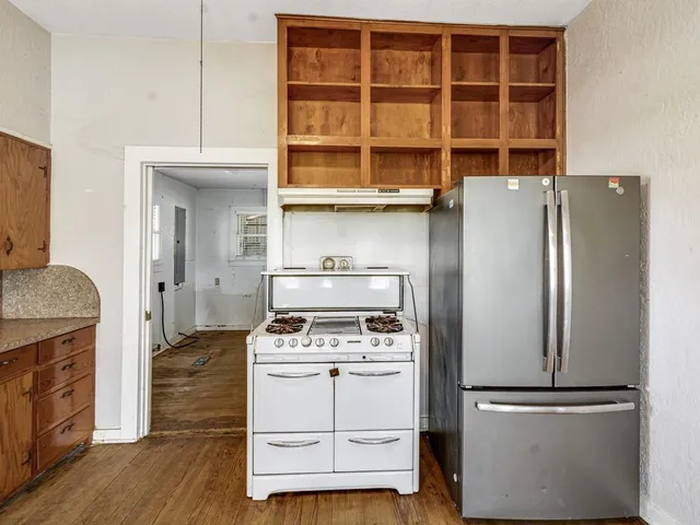 a kitchen with a refrigerator and a stove
