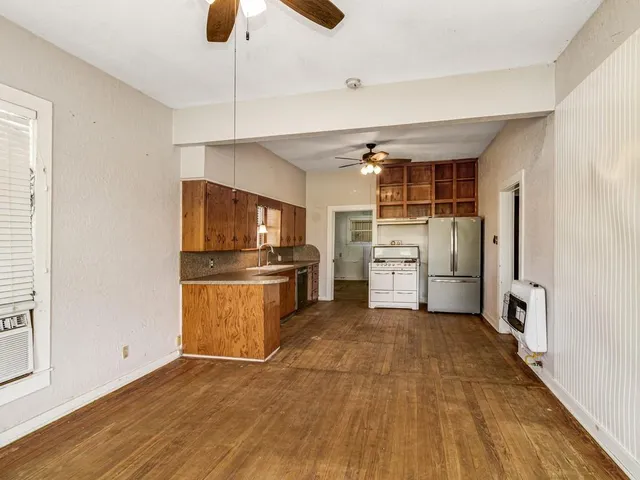 a kitchen with granite countertop a refrigerator and a stove