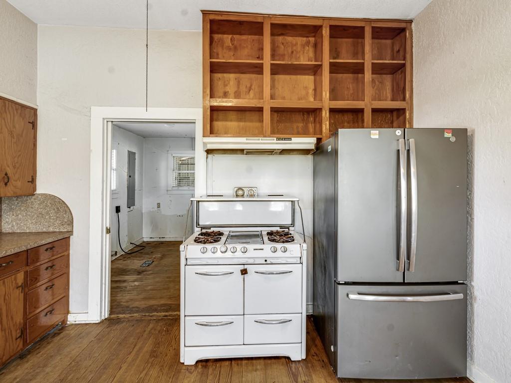 112 West Hackberry Street Malone, TX 76660 - Photo 14 of 38 a kitchen with a refrigerator and a stove