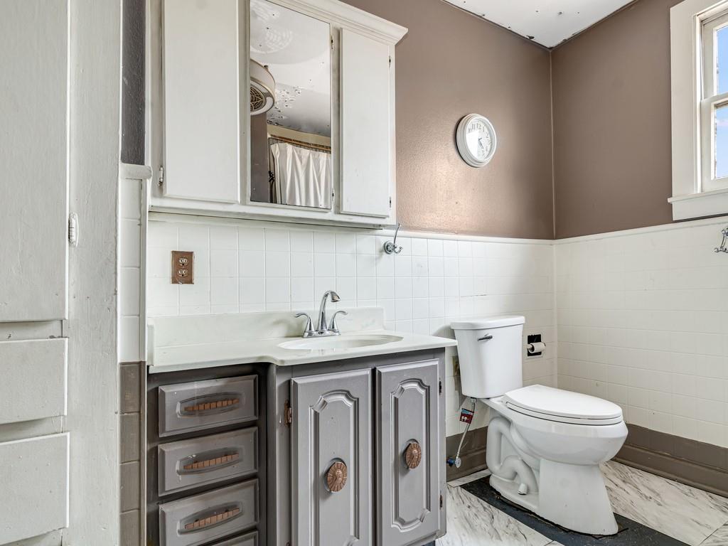112 West Hackberry Street Malone, TX 76660 - Photo 19 of 38 a bathroom with a granite countertop toilet sink and mirror