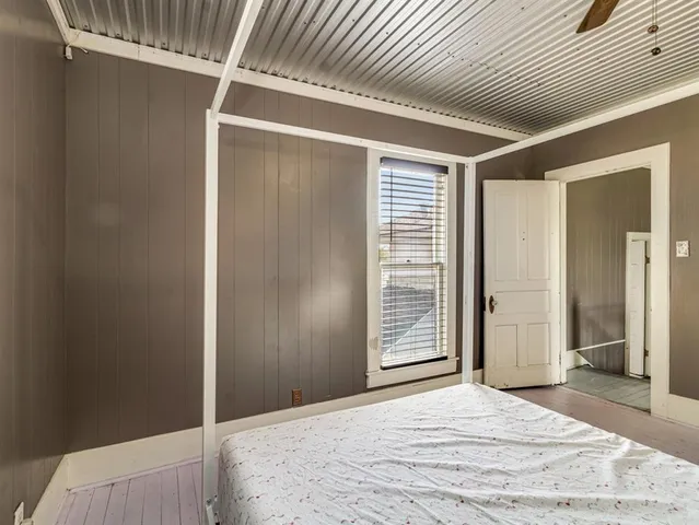 a bedroom with a bed and a window