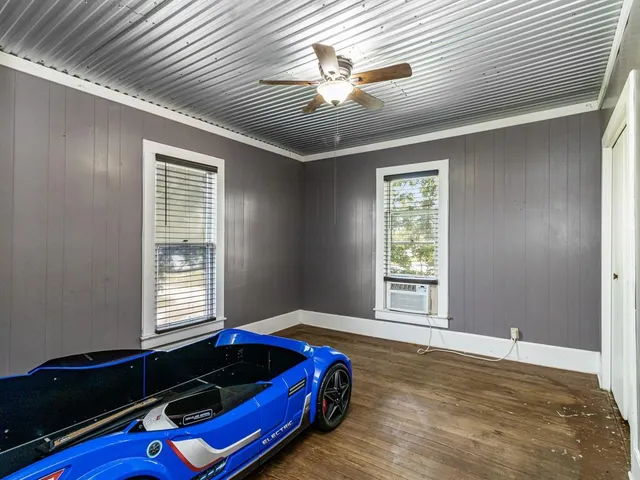 a bed sitting in a bedroom next to a window