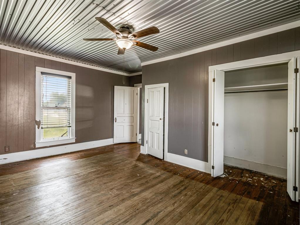 112 West Hackberry Street Malone, TX 76660 - Photo 25 of 38 an empty room with wooden floor and windows