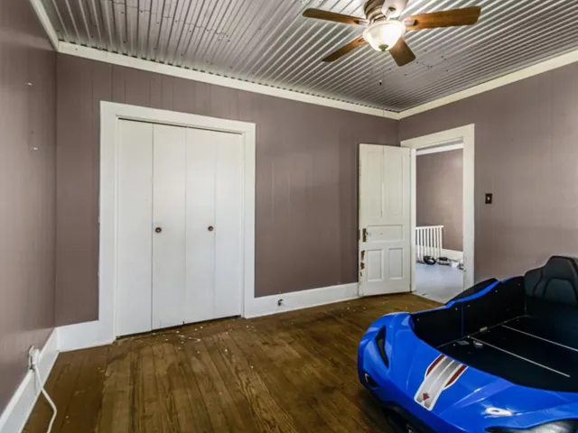 a bedroom with a bed and a chandelier