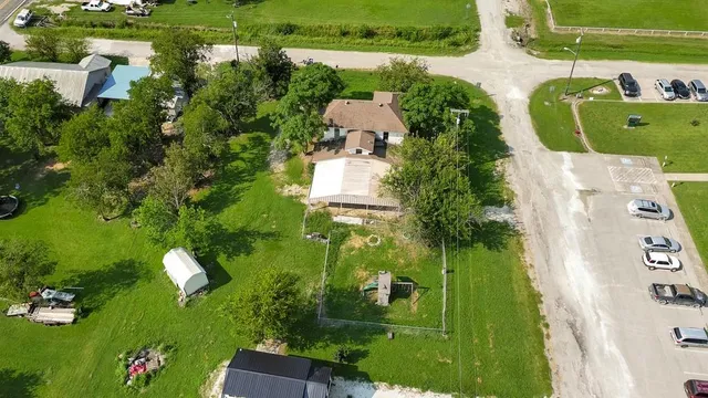 an aerial view of a house with a yard pool seating area and yard