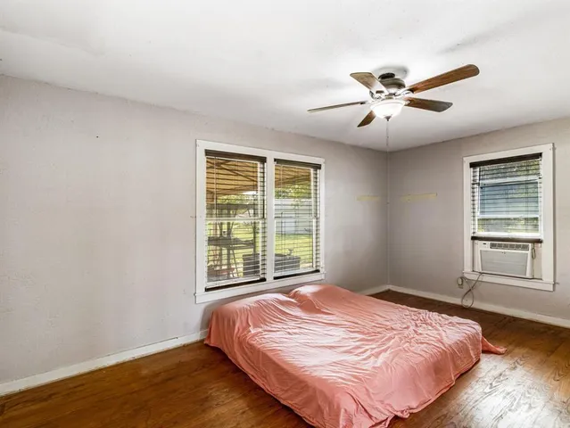a bedroom with a large bed and a window