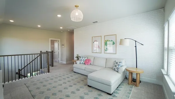 a living room with flat screen tv and a window