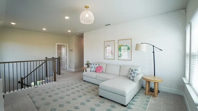 a living room with flat screen tv and a window