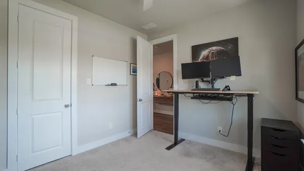 a view of a livingroom with furniture and a flat screen tv