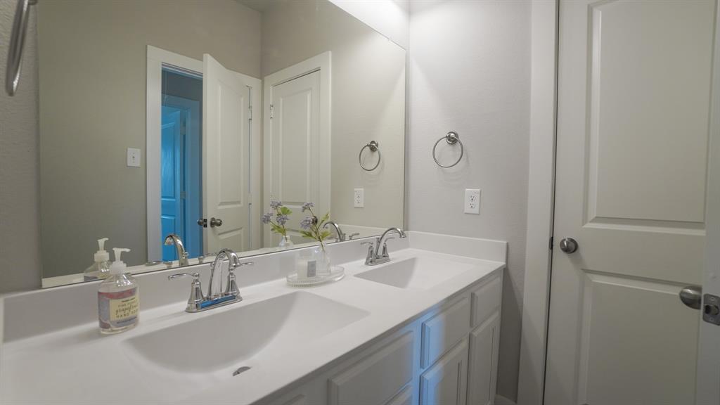 1836 Big Spring Drive Forney, TX 75126 - Photo 29 of 40 a bathroom with a granite countertop sink and a mirror