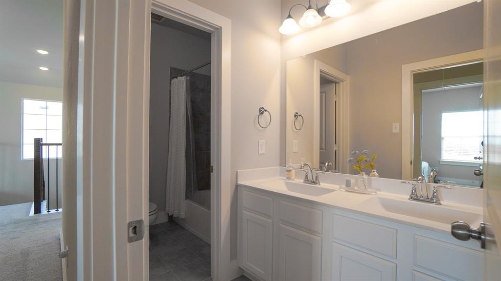 1836 Big Spring Drive Forney, TX 75126 - Photo 30 of 40 a bathroom with a double vanity sink mirror and next to a window