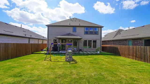 a view of a house with a yard patio and a garden