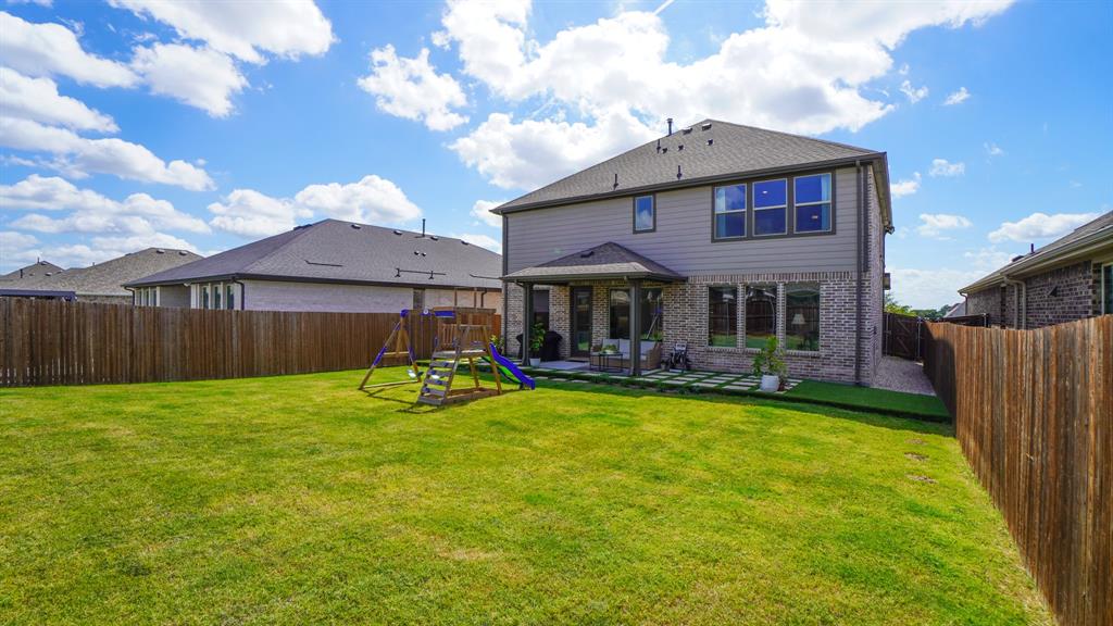 1836 Big Spring Drive Forney, TX 75126 - Photo 34 of 40 a view of a house with a yard patio and a garden