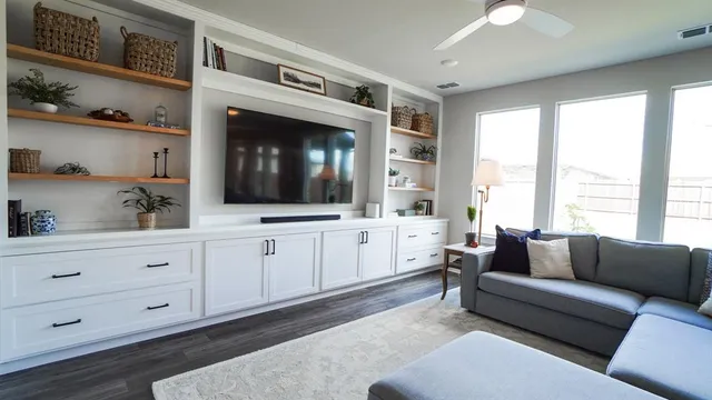 a living room with furniture and a flat screen tv