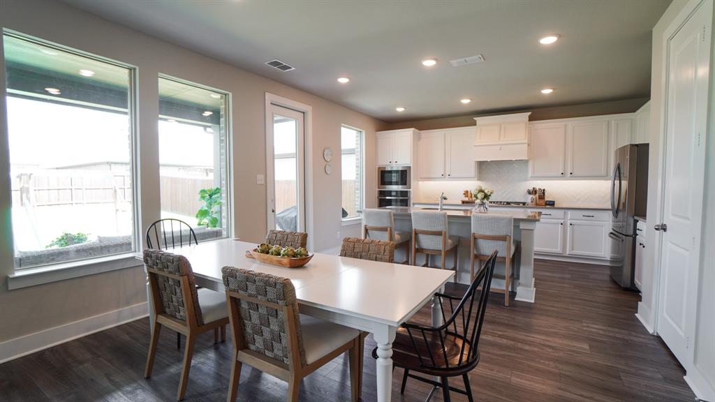 1836 Big Spring Drive Forney, TX 75126 - Photo 10 of 40 a dining room with stainless steel appliances a dining table and chairs