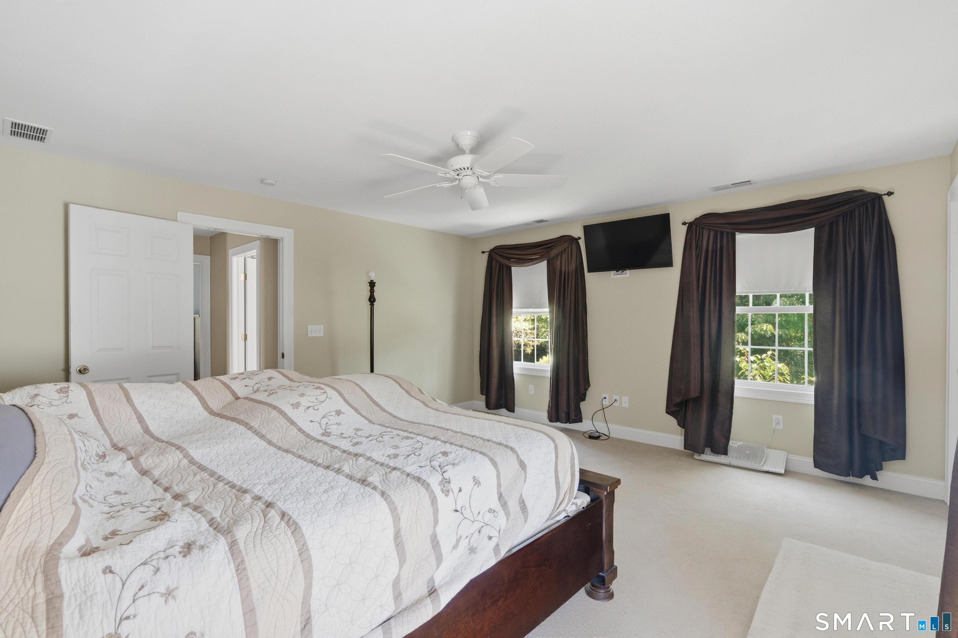 48 Case Road Burlington, CT 06013 - Photo 25 of 39 a spacious bedroom with a large bed and a chandelier
