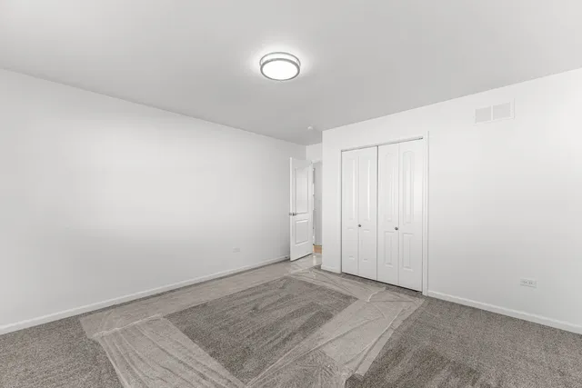 a view of a room with wooden floor and white walls