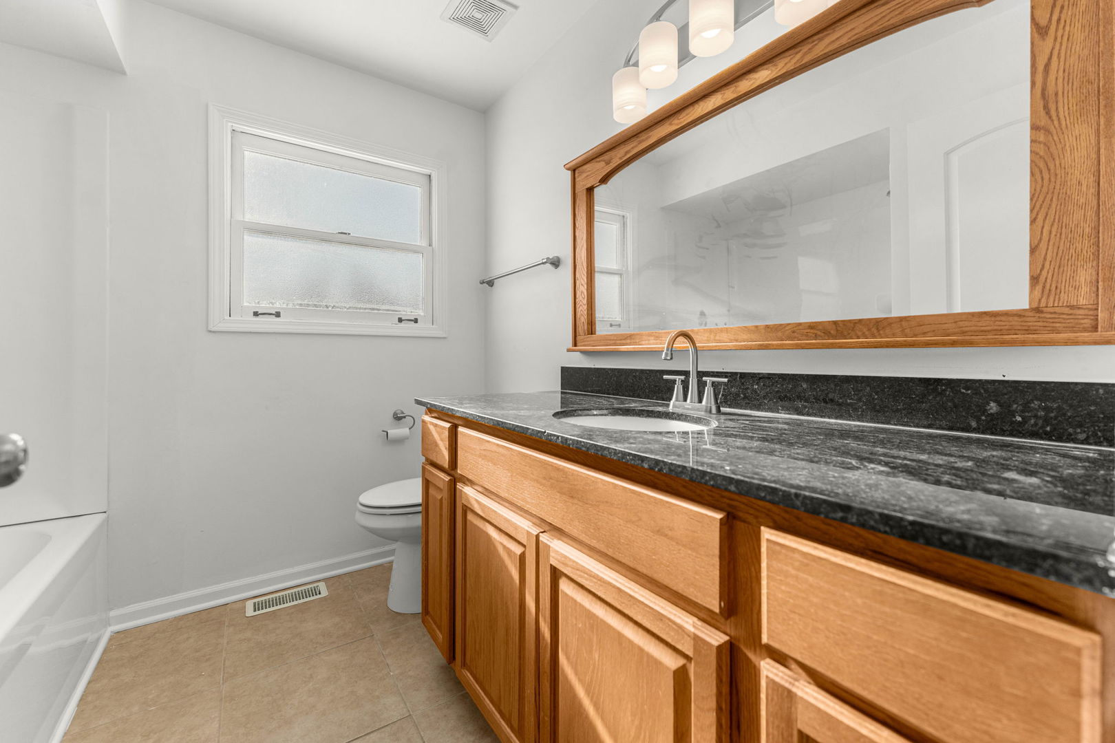 16446 Spaulding Avenue Markham, IL 60428 - Photo 16 of 27 a bathroom with a sink a vanity and a toilet