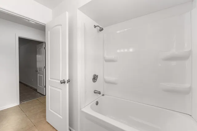 a view of an empty room and closet area