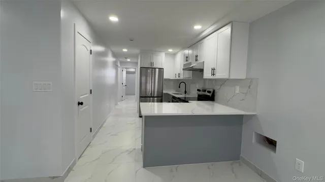 a kitchen with stainless steel appliances a refrigerator and a sink
