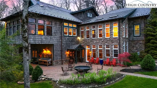 a view of a chairs and table in the patio in front of a house
