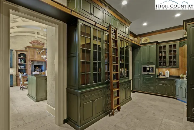 a living room with furniture a large window and gym equipment