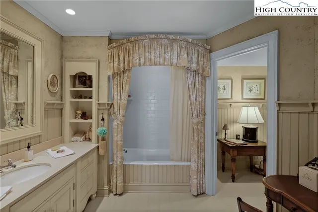 a bathroom with double vanity sinks a vanity and a shower