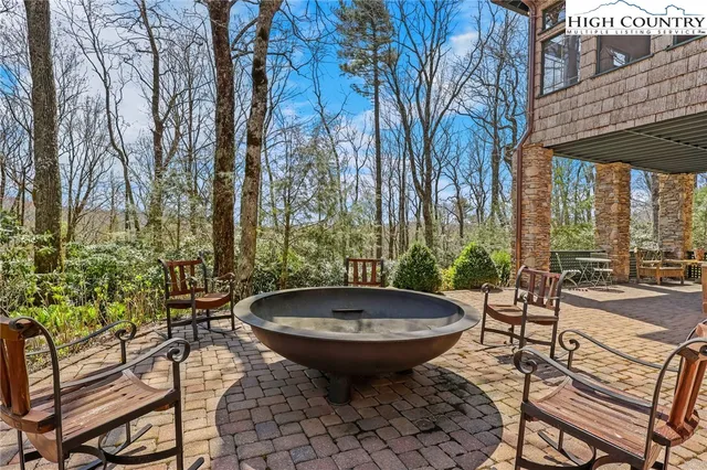 an aerial view of residential house with outdoor space and trees all around