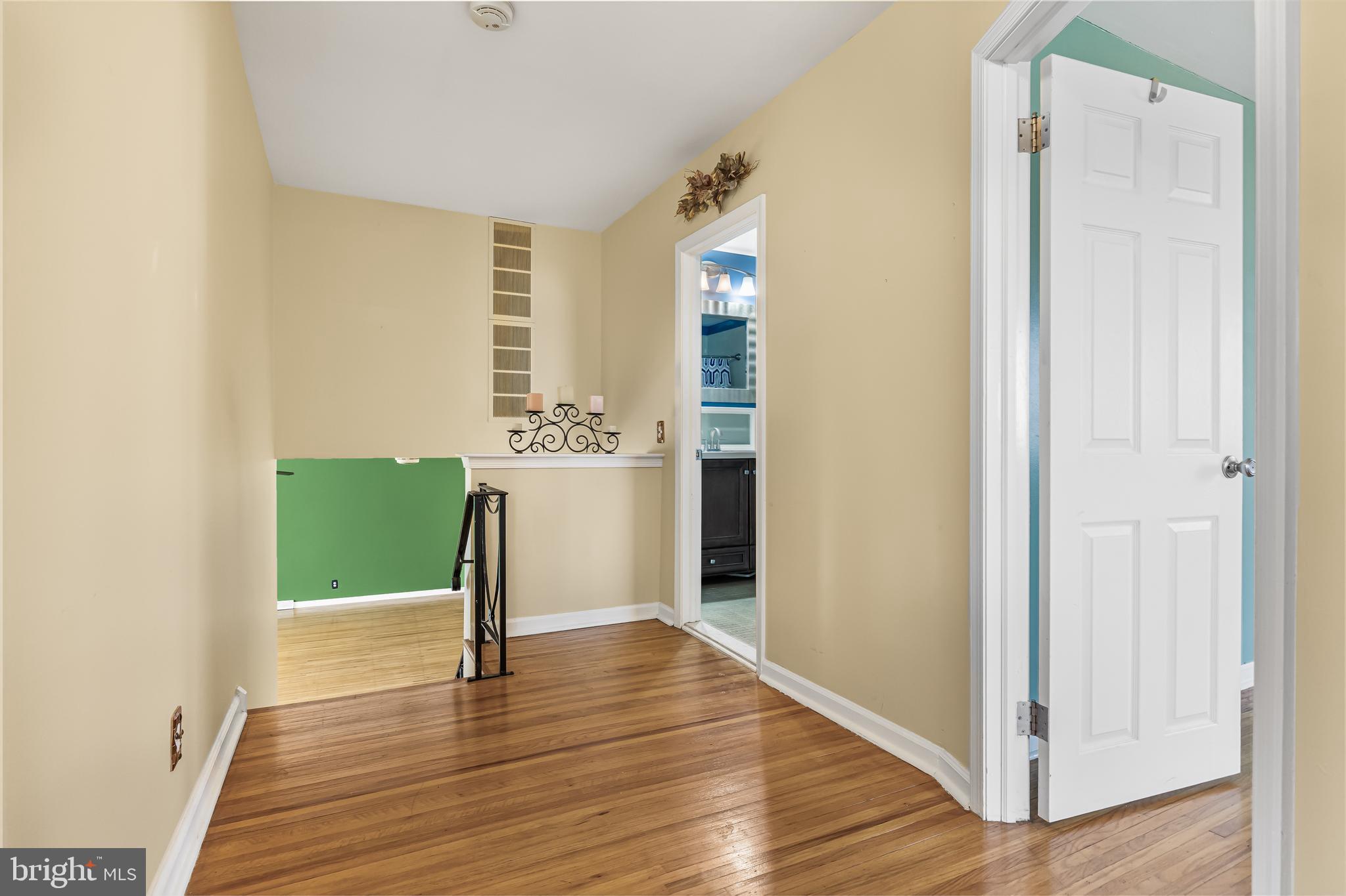 2802 Hunterdon Drive Cinnaminson, NJ 08077 - Photo 16 of 37 a view of a hallway with wooden floor windows and a fireplace