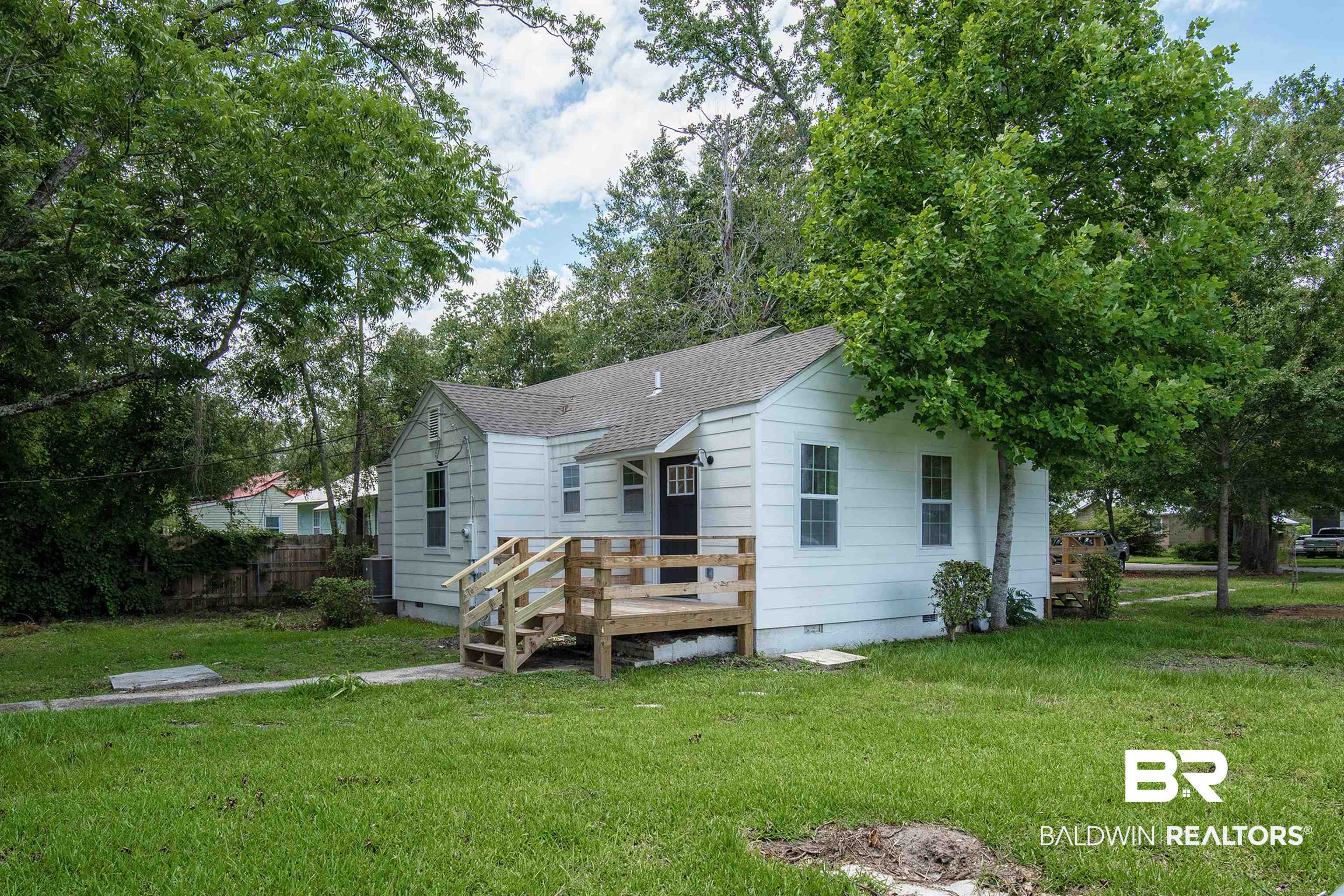 510 East Myrtle Avenue Foley, AL 36535 - Photo 3 of 22 Back of house featuring crawl space, a yard, a shingled roof, and a wooden deck