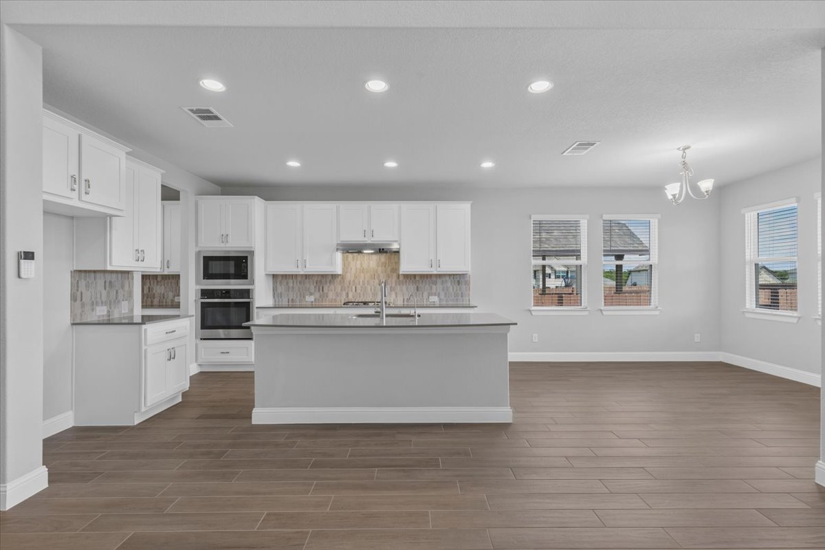 109 Rocky River Road Georgetown, TX 78628 - Photo 13 of 37 A well-appointed kitchen island anchors this open-concept culinary space.